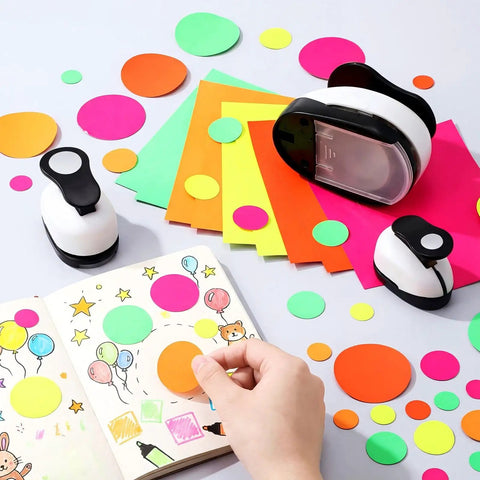Three Piece Circle Punch Set 2 Inch 1 5 Eighth Inch And 1 Inch Black Paper Punches with colorful sticker papers used for DIY albums.