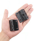 Heavy Duty Tri Fold Hinges For Cabinet Makeover held in hand, showing solid black metal design for cabinetry use.