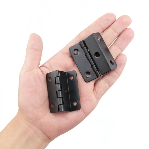 Heavy Duty Tri Fold Hinges For Cabinet Makeover held in hand, showing solid black metal design for cabinetry use.