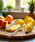 Two Pack Stainless Steel Pineapple Eye Peeler And Remover Tool, V Shape Eye Cutter on kitchen counter with fruits
