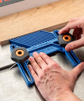 Adjustable Featherboard 11/16 Inch in use on table saw showing hands adjusting the blue ABS plastic for safer cleaner cuts