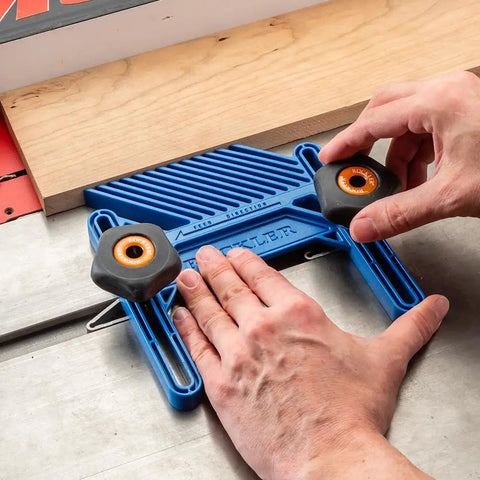 Adjustable Featherboard 11/16 Inch in use on table saw showing hands adjusting the blue ABS plastic for safer cleaner cuts