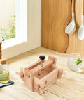 Wooden Tofu Press Mold Kit For DIY Homemade Tofu Making, 13x17x9.5cm on a kitchen counter with oil and spices