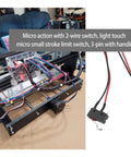 Micro limit switch with wires connected to CNC machine, showing installation and 3-pin setup.