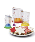 Go-To Nesting Measuring Beaker Set 7 Pieces Multicolored Kitchen with flat bases and a plate of star-shaped cookies