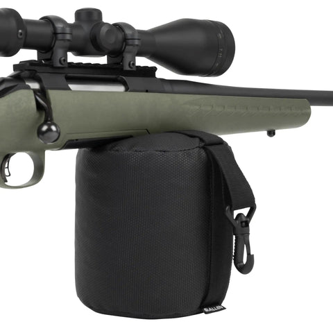 Rifle resting on Eliminator Cylinder Front Bag Filled For Shooting Stability, Grab And Go Portable Web Handle, Black.