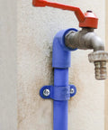 Outdoor water faucet attached with All In One Concrete Anchors And Screws Kit For Masonry Projects on a cement wall.
