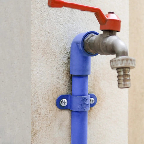 Outdoor water faucet attached with All In One Concrete Anchors And Screws Kit For Masonry Projects on a cement wall.