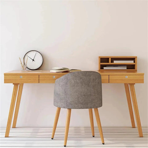 Modern wooden desk with drawers, a clock, books, and a gray chair in a minimalistic setting.