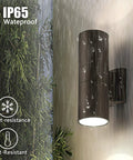 Two Pack LED Outdoor Wall Lights 14W 2700K Matte Black Aluminum Up Down Cylinder Exterior Porch Patio Door Lighting Weatherproof IP65 Energy Efficient Bridgelux LED displayed outdoors in rain, wall-mounted.