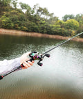 Telescopic Fishing Rod And Reel Combo 1.8m 2.1m M Power Carbon Fiber Baitcasting 5 Or 6 Sections Rod With 18 Plus 1BB Left Or Right Hand Casting Reel Fishing Set Bundles 1.8m Right Hand being used by a person next to a lake.