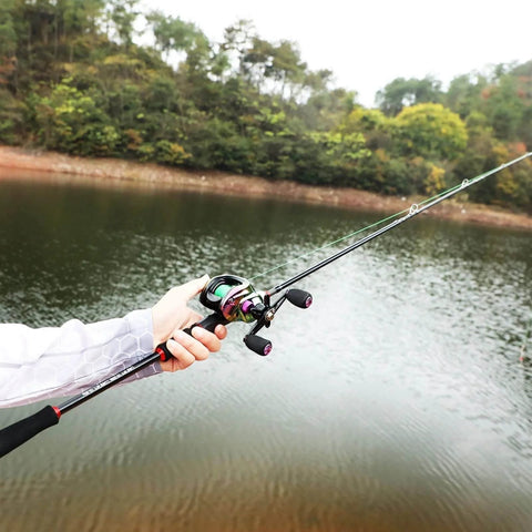 Telescopic Fishing Rod And Reel Combo 1.8m 2.1m M Power Carbon Fiber Baitcasting 5 Or 6 Sections Rod With 18 Plus 1BB Left Or Right Hand Casting Reel Fishing Set Bundles 1.8m Right Hand being used by a person next to a lake.