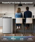 Compact 3.0 Cu Ft Upright Freezer In Silver With Moveable Shelves And A Lean Vertical Build Made For Tight Apartments Or Small Kitchens, beside two people at a kitchen counter.
