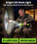 Man using Lock On Trigger Cordless Electric Grease Gun Workhorse Kit with 40 Inch Hose and LED Light on tractor wheel