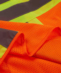 Detail of Heavy Duty Neon Orange Mesh Safety Vest With Seven Pockets And 3M Reflective Tape showing breathable fabric and bright colors.