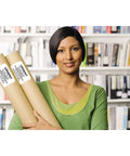 A woman holding two rolled-up documents with labels in front of a bookshelf, demonstrating the Ultra Fast Network Label Printer With Bluetooth And Ethernet Wireless Connectivity Slick Monochrome Printing Up To One Hundred Ten Labels Per Minute Dead Simple Setup For Professional Workflows.
