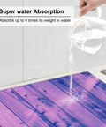 Light Purple Wood Grain Dish Drying Mat For Kitchen Counter, demonstrating super absorbent microfiber surface soaking up water.