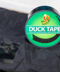 Roll of black color duct tape for all purpose heavy duty projects, shown with taped fabric, removable up to three weeks use