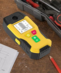 Wall Scanner Stud Finder 6-in-1 Metal Detector Auto Shutoff LCD(Yellow) on a wooden table with tools and drawings.