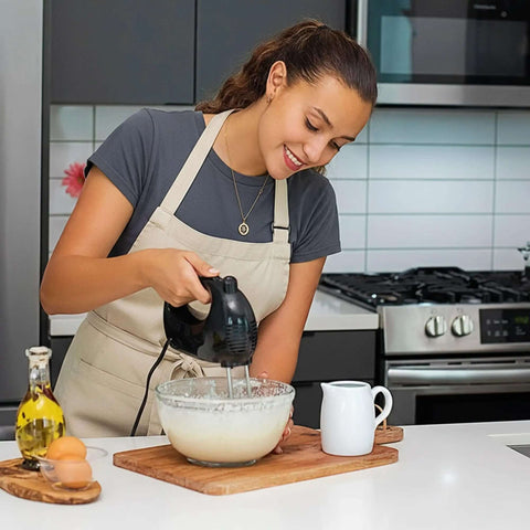 Woman using 5 Speed Corded Hand Mixer With Stainless Steel Whisks, Compact Portable Design, Snap On Storage Case, 150W Lightweight Black Handheld Mixer HM151B in kitchen