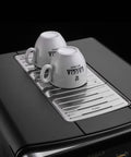 Accademia Luxury Italian Fully Automatic Espresso Machine With 19 On Demand Beverages Massive Customization Glass Touchscreen Commercial Steam Wand Brushed Stainless Steel Build Made In Italy top view with cup warmer and two cups