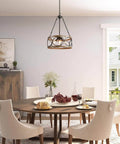 Farmhouse Drum Chandelier With Faux Wood Finish hanging over dining table, modern open-frame light fixture for living spaces.