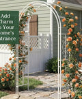 Arch Metal Outdoor Garden Arbor Montebello White 7 Feet Tall Iron Trellis Lattice For Climbing Plants Wedding Arch And Outdoor Patio Decor For Yard Entryway with orange flowers in a garden setting.