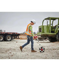 Person using Built Like A Tank 12 Inch Digital Measuring Wheel on a construction site for property surveys.