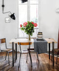 Built Tough As Nails Heavy Duty Table Legs, 28 Inch Adjustable F Shape Base, Black Finish on dining table with vase of flowers.
