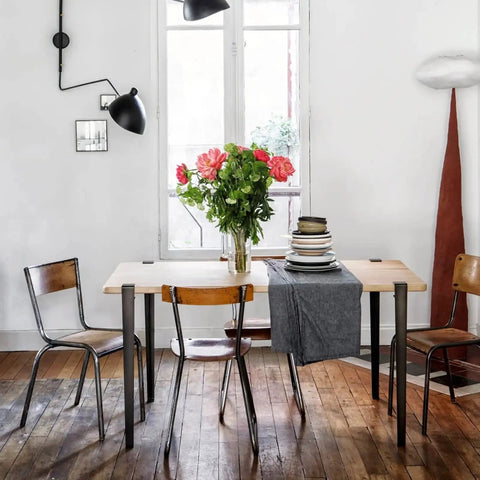 Built Tough As Nails Heavy Duty Table Legs, 28 Inch Adjustable F Shape Base, Black Finish on dining table with vase of flowers.
