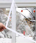 Ditch The Winter Chill With Adjustable Clear Window Insulation Kit Featuring Tough Adhesive Strips Reusable Plastic Film Wrap on window.