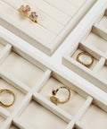 Totally Sweet Beige Linen Jewelry Display Tray With Sixteen Grid Slots For Rings Necklaces And Bracelets Ultra Soft Fabric Organizer view showing rings in compartments.