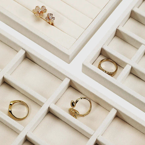 Totally Sweet Beige Linen Jewelry Display Tray With Sixteen Grid Slots For Rings Necklaces And Bracelets Ultra Soft Fabric Organizer view showing rings in compartments.