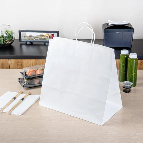 Sturdy White Paper Shopping Bags With Handles 14.2 By 8.3 By 13.2 Inches 100 Pack Durable Grocery Gift Bags on a table