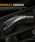 Tesla To SAE J1772 EV Charging Adapter Black 48A 250V AC on console, showcasing compact design for easy on-the-go charging.