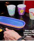 Colorful painted stoneware pots and tray from Paint And Plant Stoneware Flower Garden Kit For Kids 6 To 12 in oven for baking