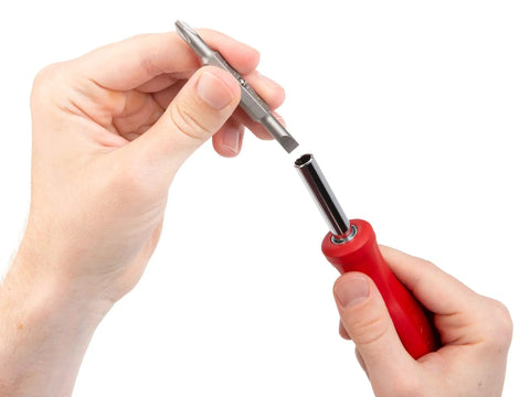 Inserting a bit into Six In One Phillips And Slotted Multi Bit Driver Kit With Handy Compact Handle and Nut Driver Bit Tube