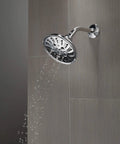 5-Setting H2OKinetic Trad Raincan Shower Head in matte black with easy touch clean spray holes installed on bathroom wall