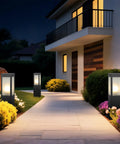 Modern Outdoor Bollard Pathway Lights Rock Solid Black Aluminum Yard Walkway Lamps With Waterproof White Glass Hardwired E26 Base For Totally Weather Ready Garden Posts illuminating a pathway in front of a house.