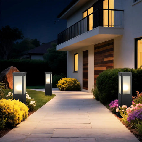 Modern Outdoor Bollard Pathway Lights Rock Solid Black Aluminum Yard Walkway Lamps With Waterproof White Glass Hardwired E26 Base For Totally Weather Ready Garden Posts illuminating a pathway in front of a house.
