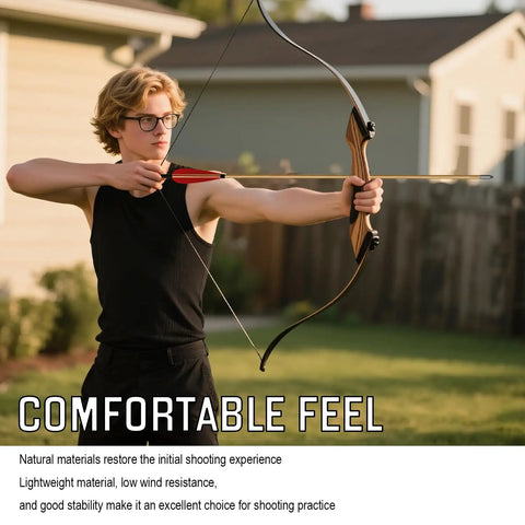Archer aiming with a bow using a 33 Inch Handmade Wooden Archery Arrows Set With Turkey Feather Fletching, outdoor setting.
