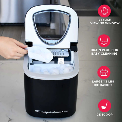 Go To Compact Countertop Ice Maker With 26 Lb Per Day Capacity, Black Finish being used with hand scooping ice