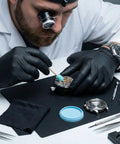 Watchmaker using 13 Piece Watch Repair And Cleaning Kit With 10 Willow Sticks And 2 Pieces Watchmaker Cleaning Clay on wristwatch