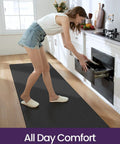 Woman standing on black Cushioned Anti Fatigue Kitchen Floor Mat 23x59 Inch Wide Runner Rug With Memory Foam Padding Waterproof Design