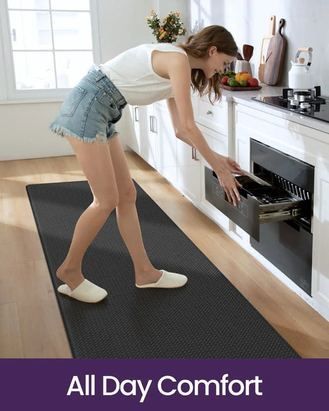 Woman standing on black Cushioned Anti Fatigue Kitchen Floor Mat 23x59 Inch Wide Runner Rug With Memory Foam Padding Waterproof Design