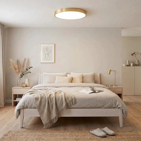 Modern bedroom with minimalist decor featuring ceiling light fixture on beige ceiling, cozy bed, and neutral tones