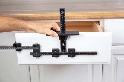 Hand using Rapid Center Extension For Extending End Stop Reach In Cabinet Hardware Installations On Oversized Drawer Fronts, fitting TP jigs