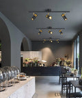 Three Light Black Track Lighting With Rotatable Heads GU10 Ceiling Spotlights illuminating a modern living room.