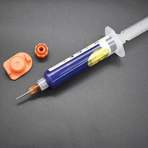 10ML Blue UV Solder Mask Kit With Needle And Push Tool For PCB on gray background, needle attached, orange cap visible