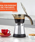 Heavy Duty Cast Aluminum Electric Espresso Maker Brews Three Or Six Cups Slick Silver Design with coffee and cookies.